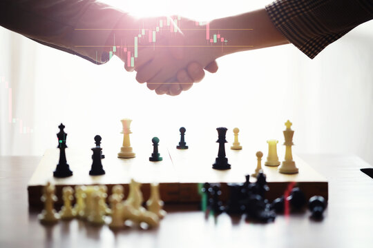 Black and White chess with player, Businessman and Businesswoman shaking hands after end game of thinking strategy to moving chess figure in competition with opposite player and planning.