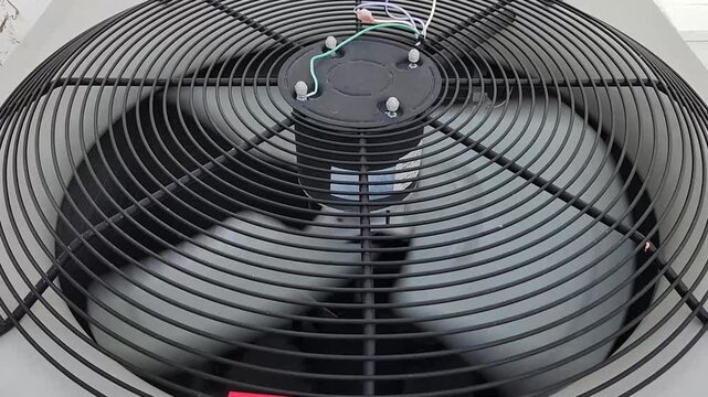 Operating air conditioner condenser fan viewed from above