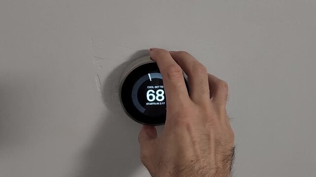 Close up of smart thermostat set to cooling mode