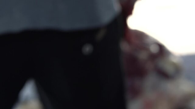 Closeup of a person wearing black athletic shorts with a small logo