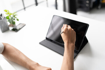 Using stylus on tablet for digital note taking and productivity technology concept. © Charlie's