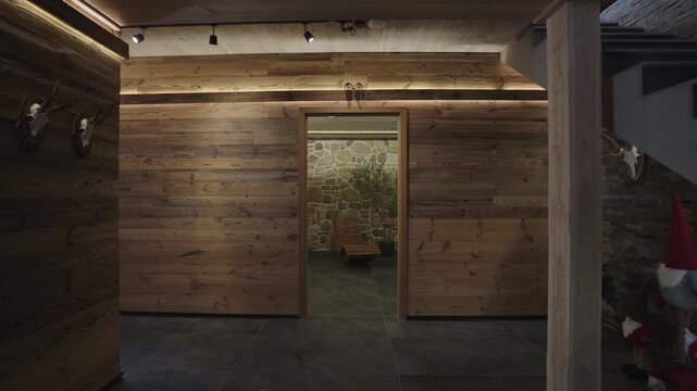 Modern sliding pocket door automatically closing in a luxurious alpine chalet with wooden walls