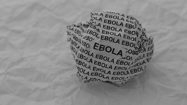 Crumpled paper ball with words Ebola on a crumpled white paper background