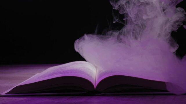 An open book on a dark background is enveloped by thick, magical smoke illuminated by a mysterious and changing purple light. Concept of magic, forbidden knowledge, and fantasy stories.
