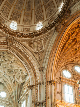 View of the ornate Renaissance dome and intricate stone carvings inside the Mosque-Cathedral in Cordoba, Andalusia, Spain.