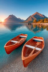 Obraz premium Two wooden rowboats on a calm alpine lake at sunrise with mountain reflections and peaceful shore
