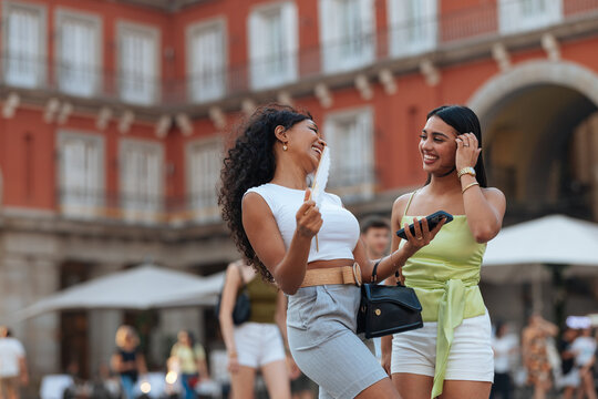 Women friends enjoying summer vacation in Plaza Mayor Madrid