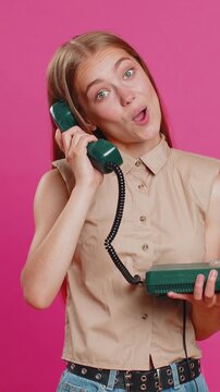 Hey you, call me back. Young woman talking on wired landline vintage telephone of 80s, advertising proposition of conversation, online shopping. Blonde adult lady isolated on pink studio background