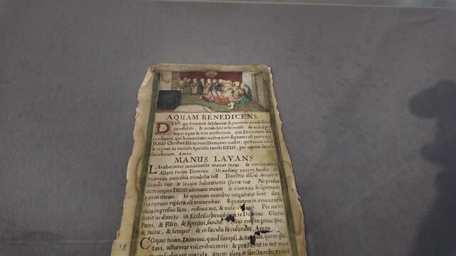 Medieval parchment with intricate borders, vivid artwork and elegant script referencing the blessing of water.
