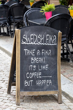 Stockholm, Sweden A blackboard sign for Swedish Fika on a sidewalk. 