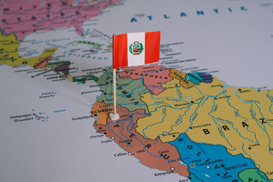 A small Peruvian flag pin placed on a map of South America, representing upcoming national elections and the democratic voting process in Peru.