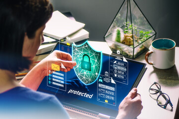 Woman holding virtual shield icon with lock, concept of data protection and cyber security.