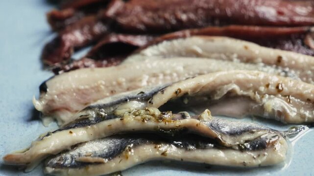 Close-up of anchovy fillet, anchovies in olive oil are the perfect appetizer for wine and vermouth in Spain. High quality 4k footage