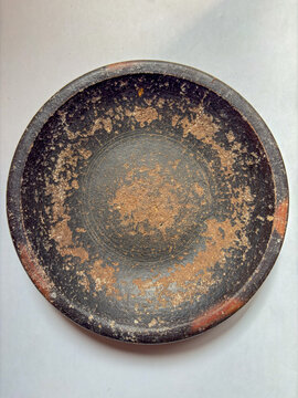Close-up of empty terracotta earthenware mortar for grinding spices on a white backdrop