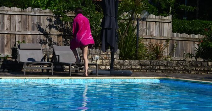 Beautiful young girl enjoying lounging in the swimming pool during heatwave