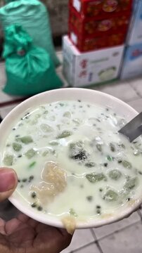 An authentic Javanese dessert drink, es dawet, consist of green sticky rice cake, coconut milk, ketan hitam, and durian fruit