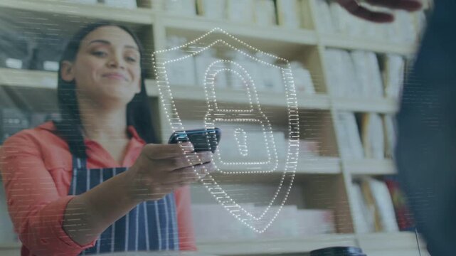 Barista handing cup and presenting reader, customer tapping smartwatch, shield securing cafe sale