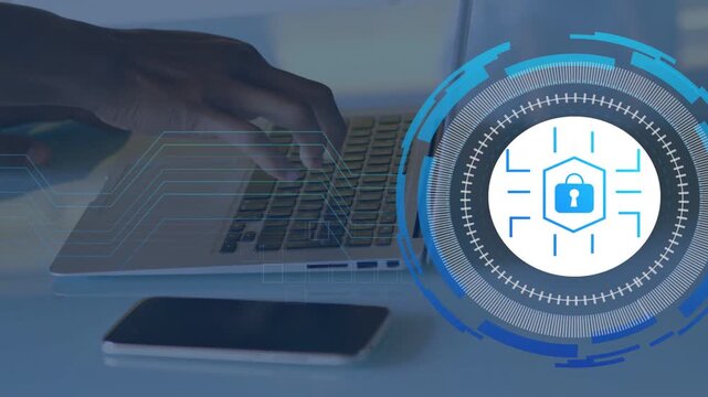 Male hand typing on laptop animating security HUD rings reaching keyboard securing data, phone idle