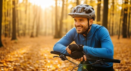 Naklejka premium Happy Male Cyclist Resting with Mountain Bike in Beautiful Autumn Forest at Sunset - Healthy Lifestyle and Outdoor Adventure