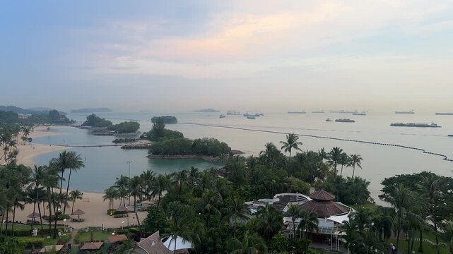 Tropical southern islands timelapse panorama with palm trees, lagoon and distant ships off Singapore sentosa island coast elevated view 4K B-roll
