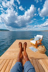 Obraz premium Relaxing on a wooden dock by a calm lake with legs stretched out and a lounge chair nearby