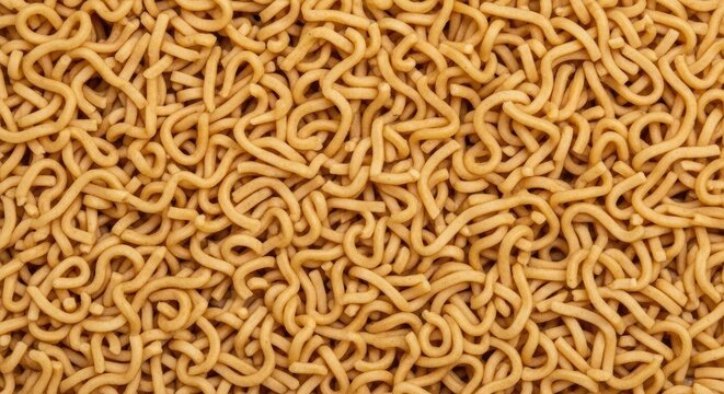 A large quantity of yellow noodles covers the entire frame. The noodles are arranged in a dense, textured pattern, resembling a chaotic, organic landscape.
