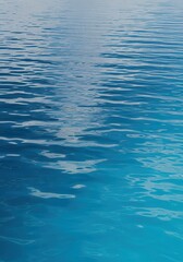 Obraz premium Calm Blue Water Surface with Gentle Ripples and Sunlight Reflections, Serene Ocean Background for Summer Travel and Wellness