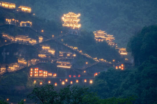 Beautiful traditional buildings illuminated with warm lights at night in the Wangxian Valley Scenic Area in Jiangxi China