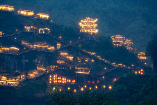 Beautiful traditional architecture illuminated with warm lights at night in the Wangxian Valley Scenic Area in Jiangxi China