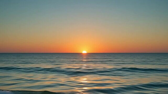 Panoramic sunset over calm ocean waves with golden sunlight reflection glowing on the water surface in a serene and peaceful coastal horizon landscape view