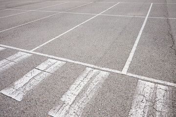 Fototapeta premium White lines painted on the ground in an asphalt parking lot