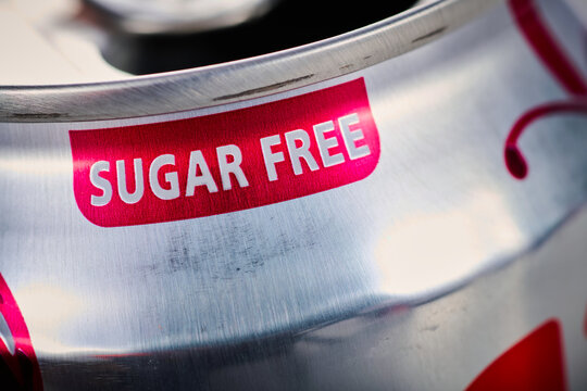 Sign indicating "sugar free" on a can of soda