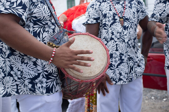 Musician playing atabaque in procession