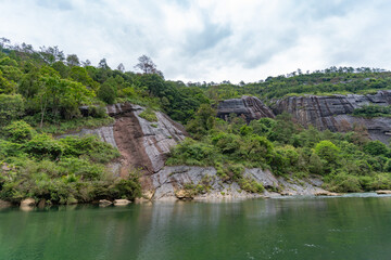 Fototapeta premium A scenic view of the lush green mountains and the river landscape in Wuyi Mountains in Fujian China