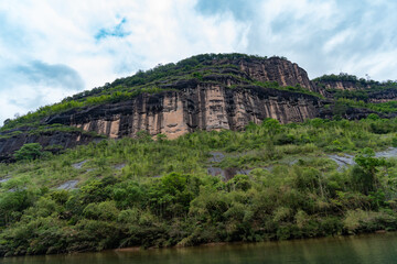 Fototapeta premium A view of the steep mountains and green forests of the Wuyi Mountains in Fujian China