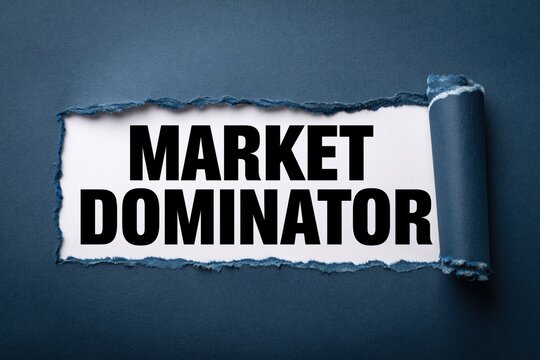 MARKET DOMINATOR text written on white paper under a torn dark blue background