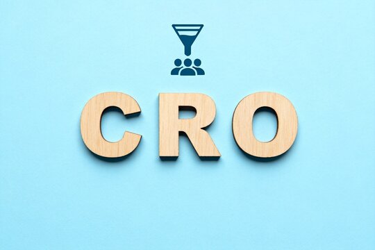 Wooden letters CRO with funnel icon