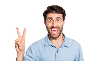 Fototapeta premium Close up photo of amazing handsome guy showing v-sign symbol greets friends in good mood wear casual denim shirt isolated white color background