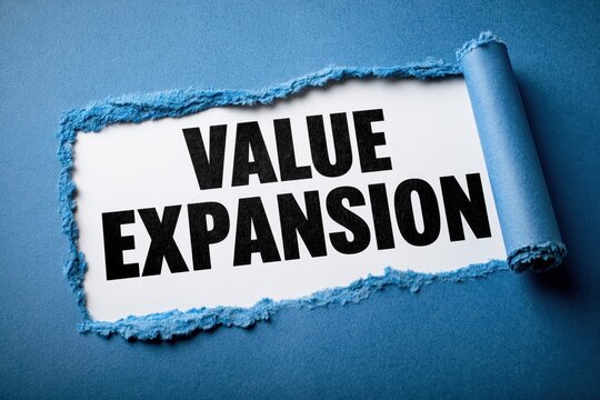 VALUE EXPANSION business growth strategy concept behind torn blue paper