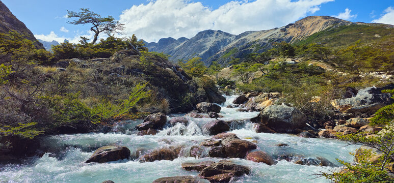 Rushing Mountain River with Cascades and Andean Peaks in Tierra del Fuego