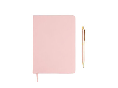 Pink notebook with pen on pink background