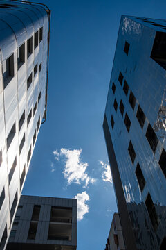 Tall buildings frame the sky in La Confluence, Lyon, France as shadow and facade angles sharpen contemporary architecture between towers