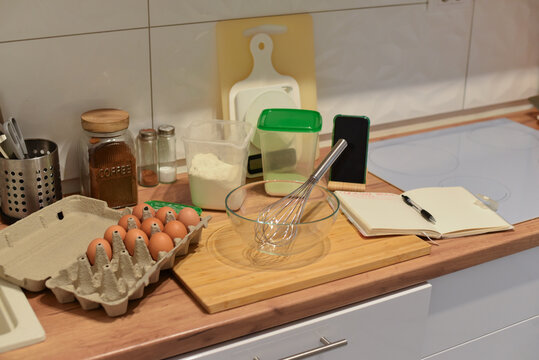 Baking ingredients and tools on wooden kitchen countertop