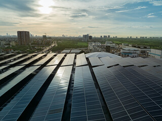 Wide rooftop solar panel system reflecting sunlight above modern industrial and commercial district in Hanoi Vietnam. © Hanoi Photography
