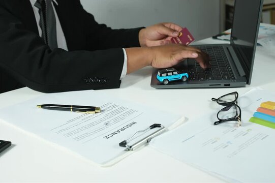 Digital banking concept, secure online payments, man holding credit card in front of laptop, online insurance, payment process, entering credit card security code on laptop, transportation insurance c