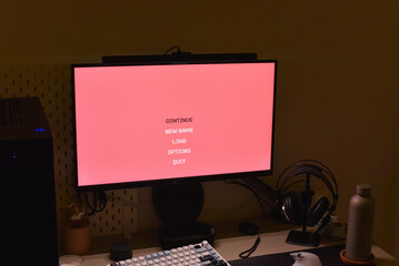 Computer monitor showing retro game menu in gaming setup © Denis Renkas