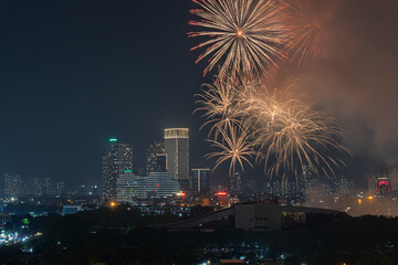 Fototapeta premium Golden fireworks display over My Dinh urban skyline during festive nighttime event in Hanoi Vietnam with illuminated city buildings.