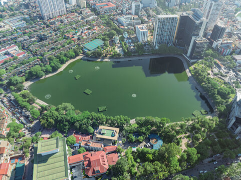 Top down aerial view of Thanh Cong Lake bordered by dense residential neighborhoods and modern office buildings in Hanoi.