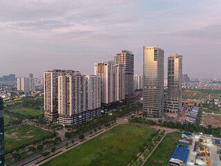 Fototapeta premium Sunset light over modern residential towers and office buildings in Ngoai Giao Doan urban district west of West Lake Hanoi.