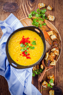 Traditional Indian style dal lentil soup dal tadka with roasted flatbread served as top view in a design pot